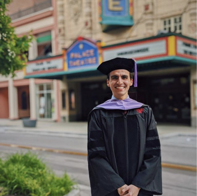 Dental Student Poses for Graduation Photo